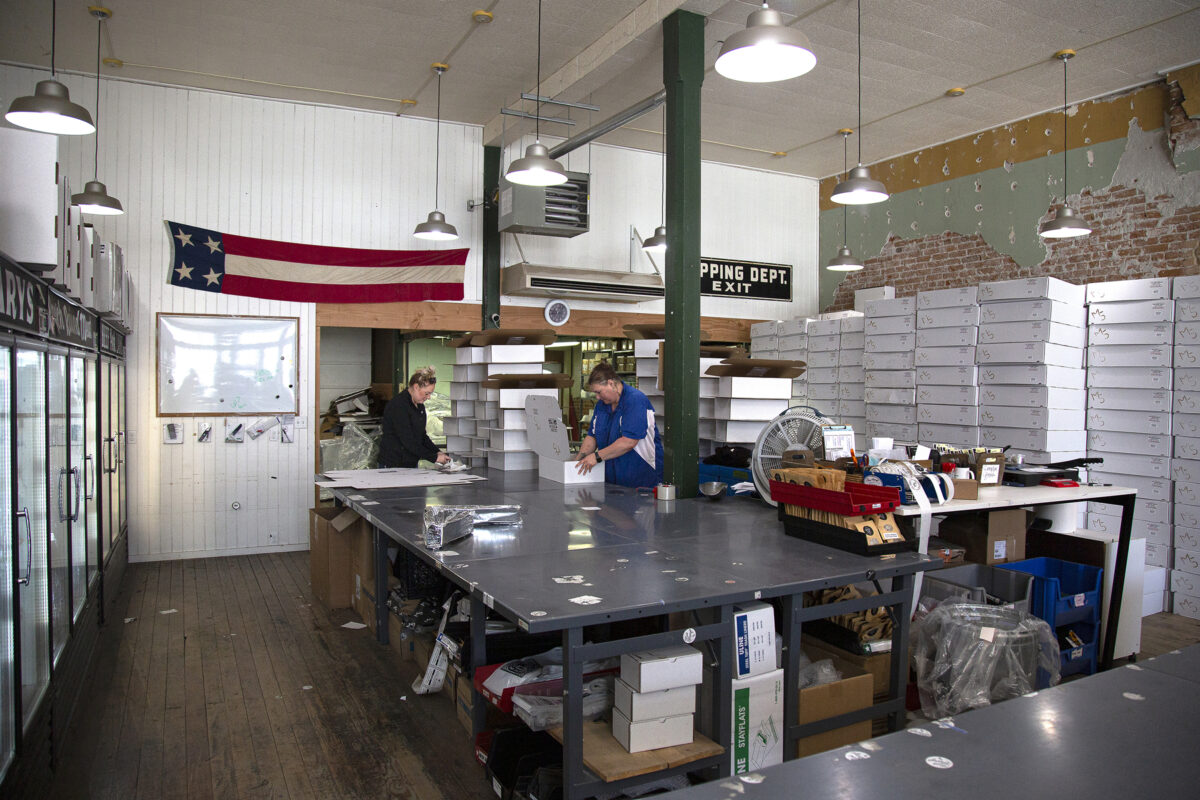 Employees package orders for Five Marys Farms in a rustic store in Fort Jones, California.