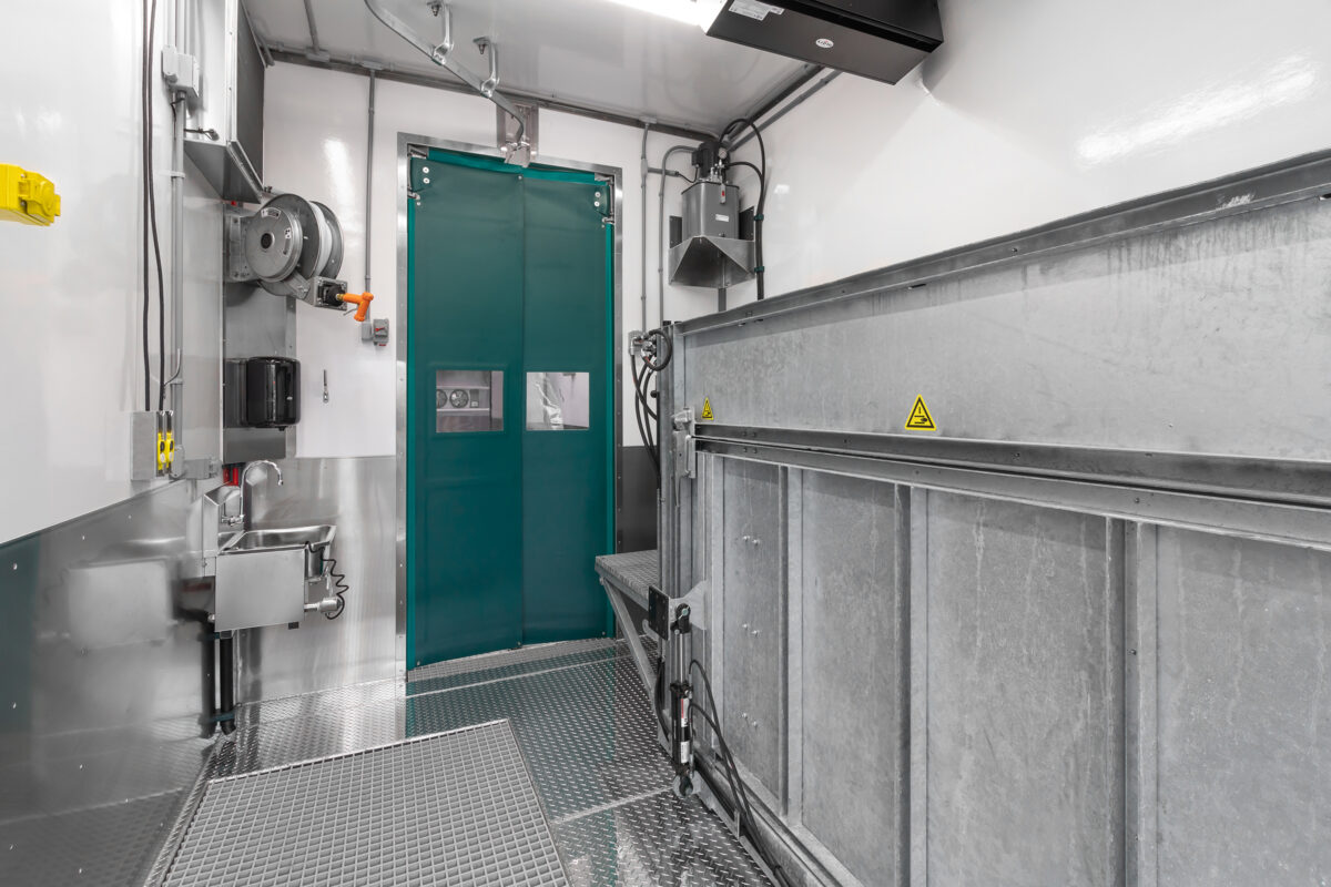 An interior view of the Knock & Bleed Room and restrainer in Friesla’s Modular Meat Processing System.