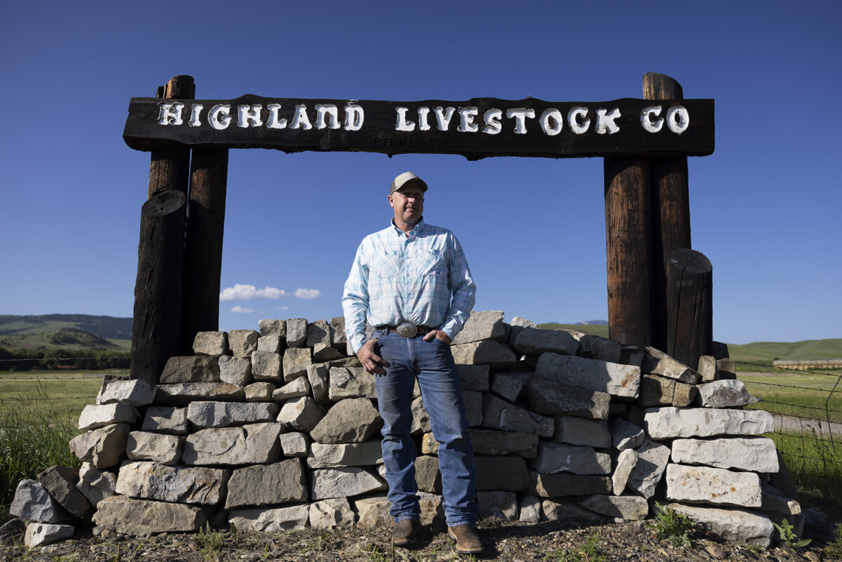 Matt Pierson, President and Founder of The Producer Partnership, in front of Highland Livestock Co timber sign overlooking a tan Friesla Modular Meat Processing System.