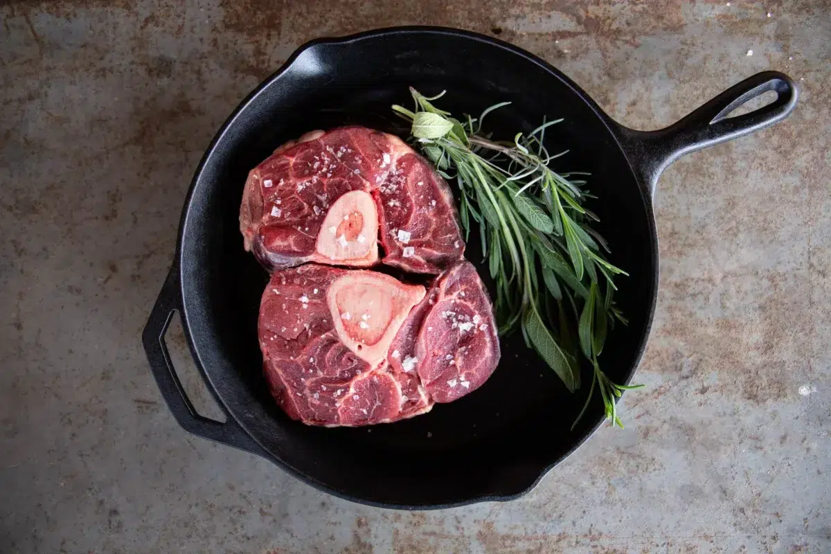 A beef cross-cut shank, or osso buco, in a cast iron skillet.